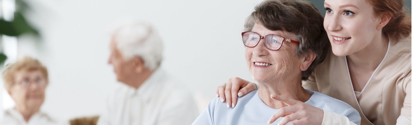 Nurse helping elderly person in nursing home