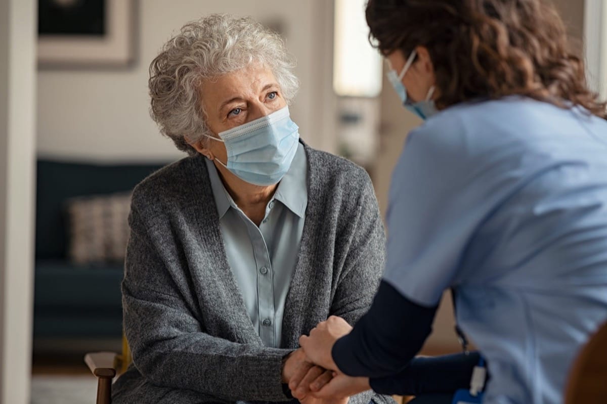 Nurse helping elderly person in nursing home